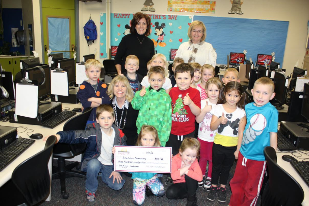 Washington County School District Foundation Director, Pam Graf (black shirt) presents a check to Santa Clara Elementary, Santa Clara, Utah, date not specified | Photo courtesy of Pam Graf, St. George News