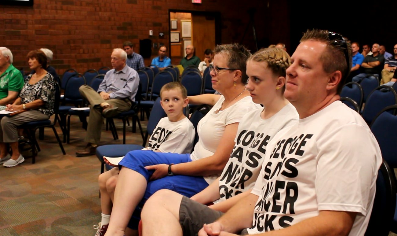 (L-R) George Stafford, his mother Jen Stafford, his older sister, and father Travis Stafford sit on the front row in the council chambers during a meeting of the St. George City Council in which a proclamation of recognizing September as Childhood Cancer Awareness Month is read, St. George, Utah, Sept. 1, 2016 | Photo by Mori Kessler, St. George News