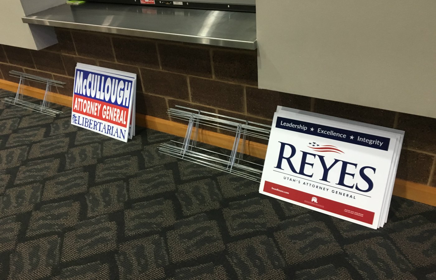 Campaign signs for Utah Attorney Libertarian candidate Andrew McCullough and Republican incumbent Sean Reyes set against the wall while the "modified" Utah Attorney General dabate takes place, St. George, Utah, Sept. 21, 2016 | Photo by Sheldon Demke, St. George News