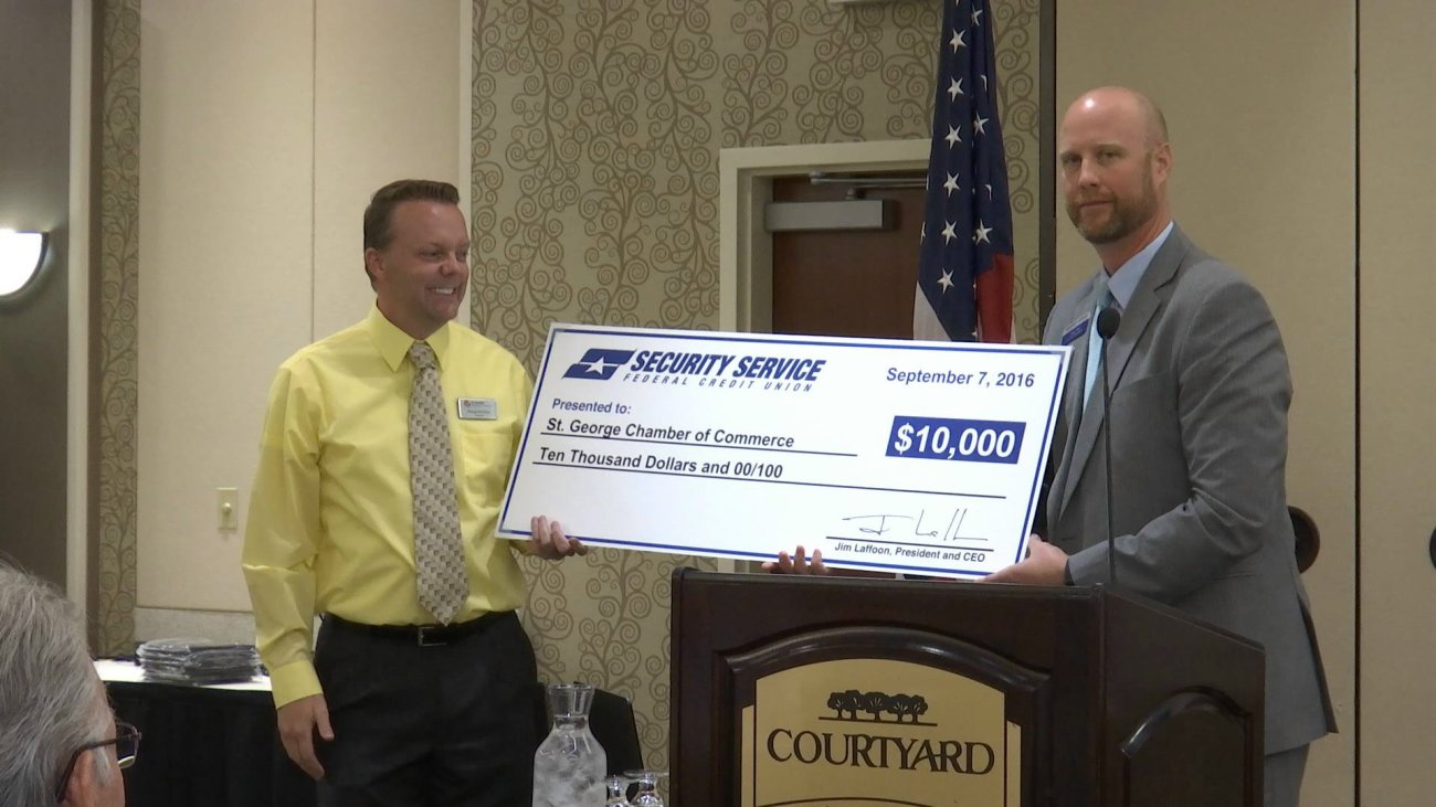 (L-R) Gregg McArthur, president/CEO of the St. George Area Chamber of Commerce, and Greg Reed, senior vice president of Security Service Federal Credit Union, holding up a $10,000 donation from Security Service Federal Credit Union going toward the renovation of the new St. George Area Chamber of Commerce building on 100 East off St. George Boulevard, St. George, Utah, Sept. 7, 2016 | Photo by Sheldon Demke, St. George News