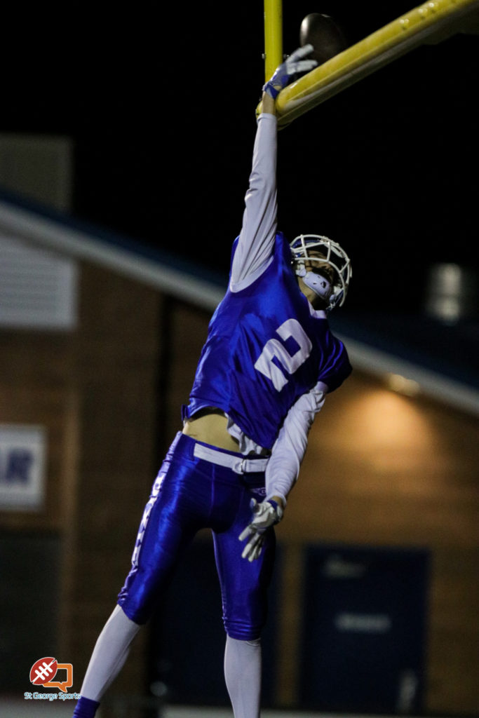 Josh Topham "dunks" over the goal post after scoring a touchdown Friday night, Hurricane at Dixie, St. George, Utah, Oct. 21, 2016 | Photo by Todd Ellis, St. George News