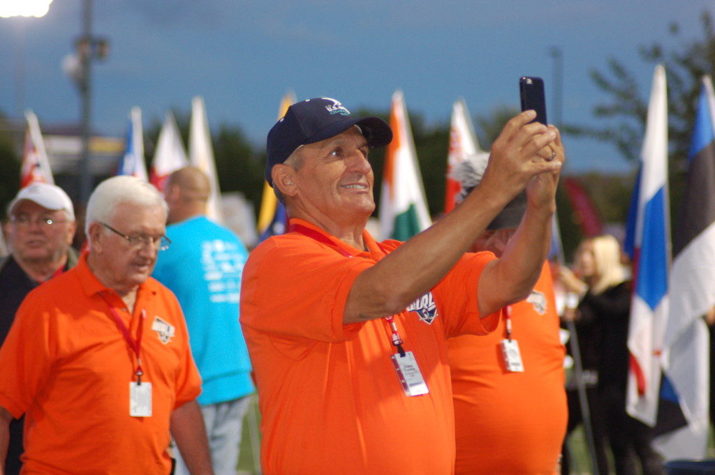 In this photo from October 2015, a Senior Games athlete takes a selfie during the opening ceremonies of the games, St. George, Utah, Oct. 6, 2015 | Photo by Hollie Reina, St. George News 