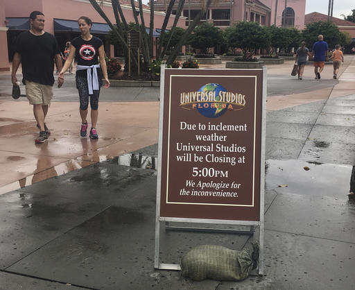 Park guests depart from Universal Studios, Thursday, Oct. 6, 2016, in Orlando, Fla. Leaving more than 100 dead in its wake across the Caribbean, Hurricane Matthew steamed toward heavily populated Florida with terrifying winds of 140 mph Thursday, and 2 million people across the Southeast were warned to flee inland. In inland Orlando, Walt Disney World, Universal Studios and SeaWorld announced plans to close early Thursday, Oct. 6, 2016 | AP Photo by Janelle Cogan, St. George News