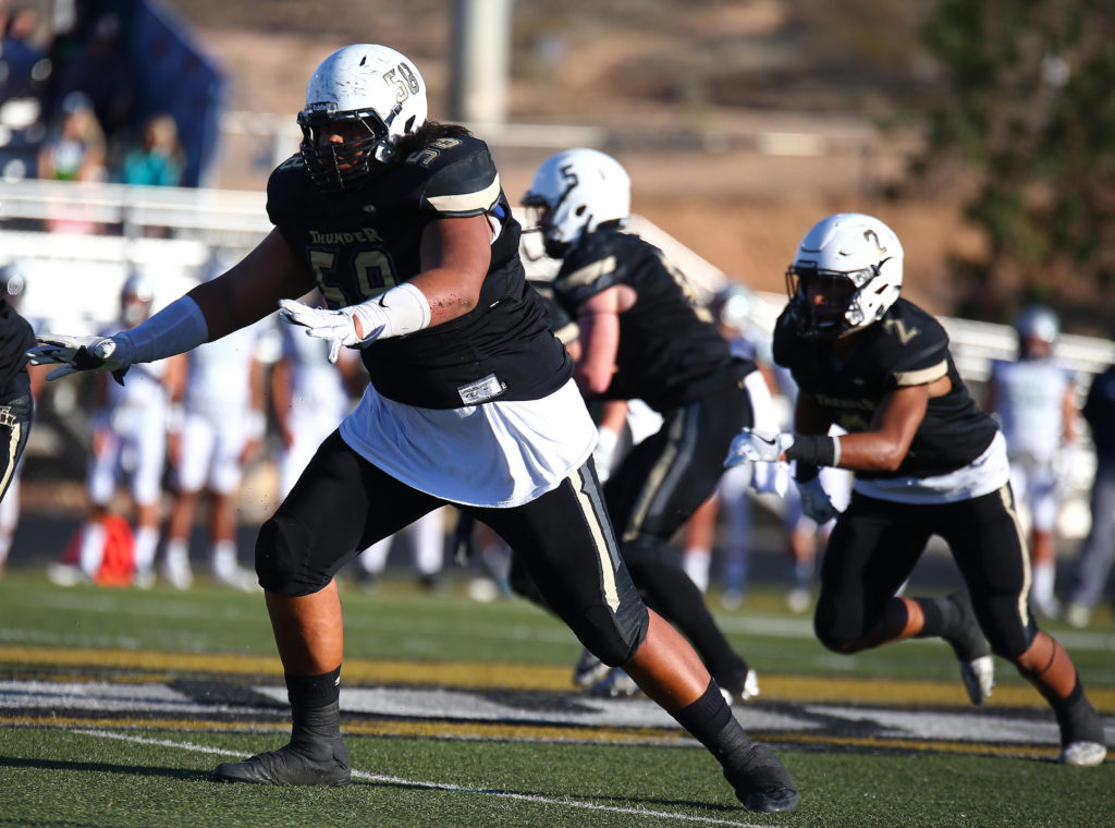 Desert Hills' Penei Sewell (58) with older brother Nephi (2) in the background, Desert Hills vs. Ridgeline, Football, St. George, Utah, Nov. 4, 2016, | Photo by Robert Hoppie, ASPpix.com, St. George News