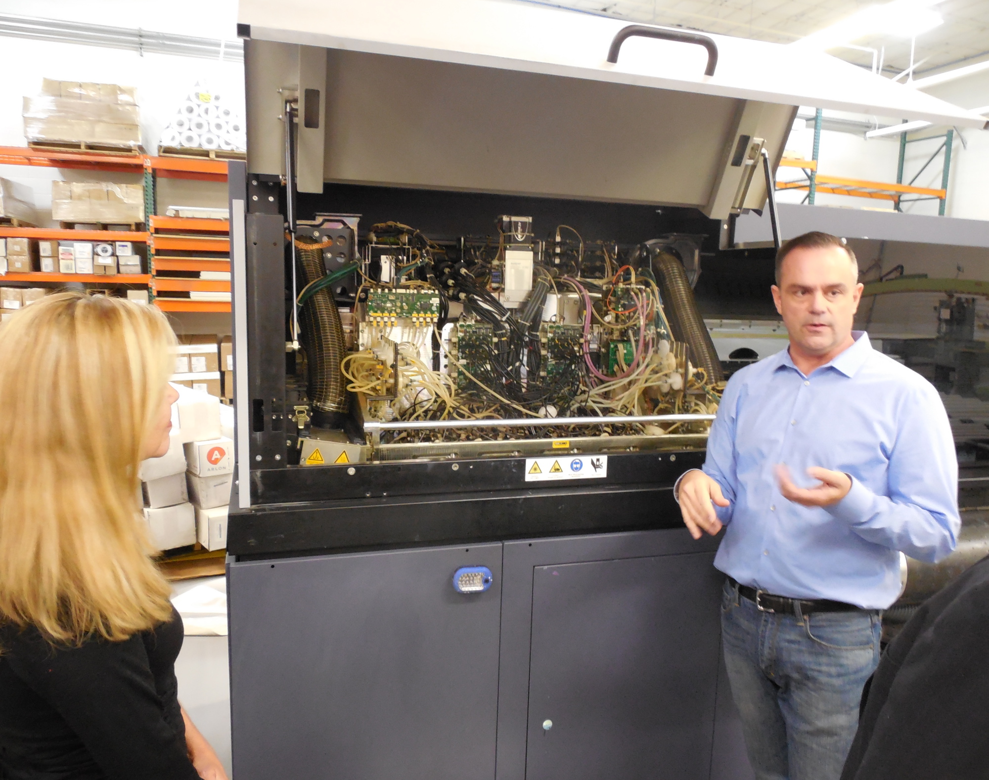 Josh Bevans shows off a high-tech printing press to Small Business Administration Regional Director Betsy Marky during a tour of Design to Print, St. George, Utah, Nov. 17, 2016 | Photo by Julie Applegate, St. George News