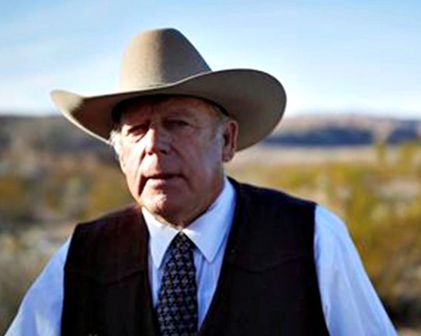 Rancher Cliven Bundy stands along the road near his ranch after speaking with media. Cliven Bundy and his wife Carol Bundy were returning from a trip to visit the family of LaVoy Finicum, a 55-year-old rancher from Cain Beds, Ariz., who died Tuesday after law enforcement officers initiated a traffic stop near the Malheur National Wildlife Refuge. It's unclear what happened in the moments before his death. Bunkerville, Nevada, Jan. 27, 2016 | AP Photo by John Locher, St. George News