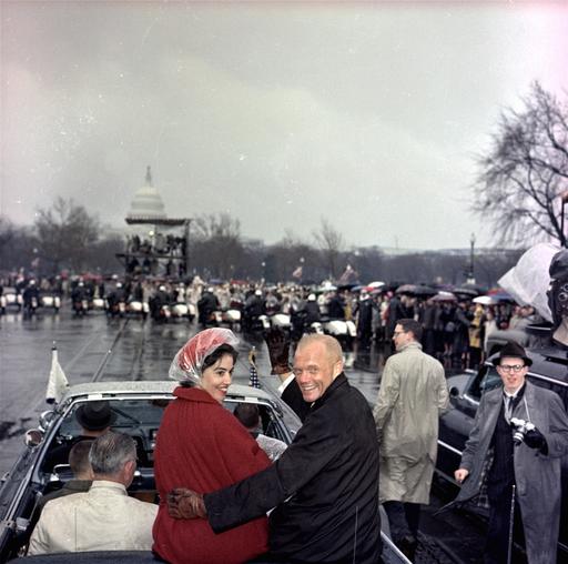 FILE - In this Feb. 26, 1962 file photo, Mercury astronaut John Glenn, and his wife, Annie, ride in the back of an open car with Vice-President Johnson during a parade in Glenn's honor in Washington. The Capitol is seen in the background. Glenn, the first American to orbit Earth who later spent 24 years representing Ohio in the Senate, died Thursday, Dec. 8, 2016, at the age of 95. (AP Photo/File)