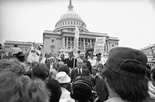 FILE - In this Friday, Sept. 23, 1977 file photo, Sen. John Glenn, D-Ohio, center, speaks to a group of Youngstown, Ohio Steelworkers on the steps of the Capitol in Washington. The group urged the government to curb steel imports and to relax pollution control requirements. Glenn, the first U.S. astronaut to orbit Earth who later spent 24 years representing Ohio in the Senate, died Thursday, Dec. 8, 2016, at the age of 95. (AP Photo/Harvey Georges, File)