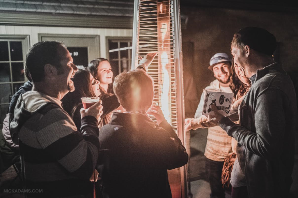 Revelers at the jazz garden stay warm by a heater during a previous Georgefest event, St. George, Utah, date not specified | Photo by Nick Adams, courtesy of Emceesquare Media Inc., St. George News