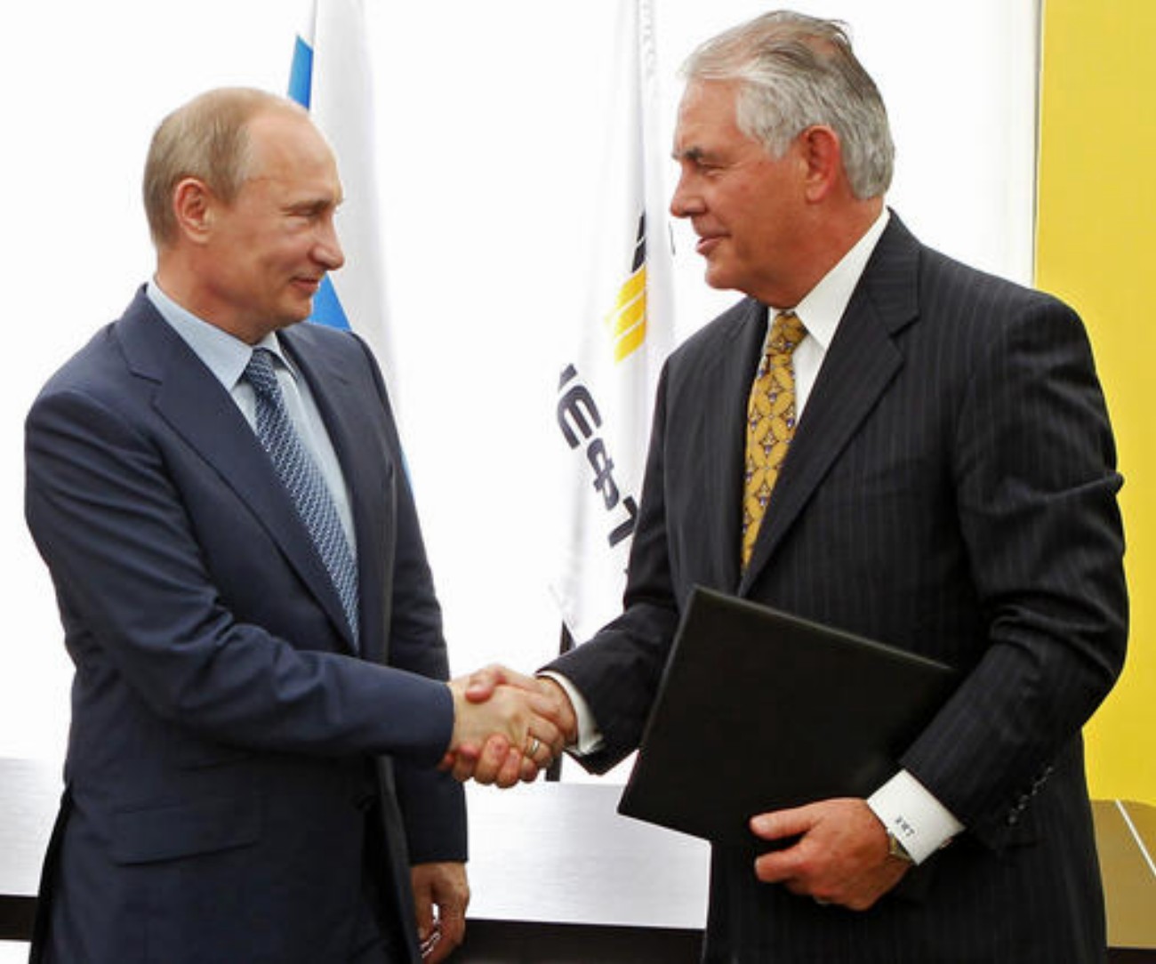 File photo from 2012: Russian President Vladimir Putin, left, and ExxonMobil CEO Rex Tillerson shake hands at a signing ceremony of an agreement between state-controlled Russian oil company Rosneft and ExxonMobil at the Black Sea port of Tuapse, southern Russia. President-elect Donald Trump selected Tillerson to lead the State Department on Monday, Dec. 12, 2016. Photo originally taken in Moscow, Russia, June 12, 2012 | Photo by Mikhail Klimentyev/RIA-Novosti, Presidential Press Service via AP, Pool