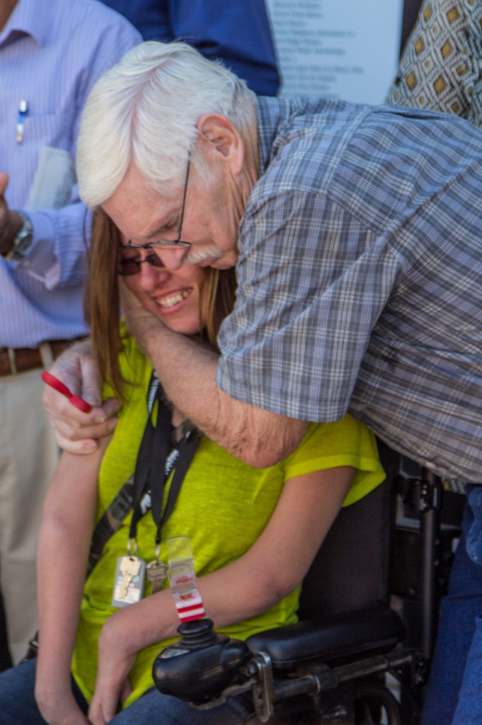 'Sweet Lindsey' Smith gets a hug from her grandfather Glen Martin at ribbon-cutting ceremony | A Home for LIndsey