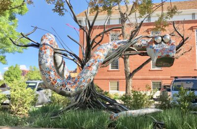 The giant snake art piece by Deveren Farely weaved through a tree, Date and location unspecified | Photo courtesy of Marianne Hamilton, St. George News