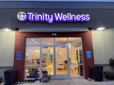 The sign for Trinity Wellness glows outside the business at night, Date unspecified, George, Utah | Photo courtesy of Katie Mitchell, St. George News