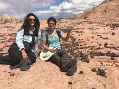 Artist Irene Kopelman and University of Utah professor, Marjorie Chan pose at the archaeological site, Kanab, Utah, Date unspecified | Photo courtesy of Marjorie Chan, St. George News