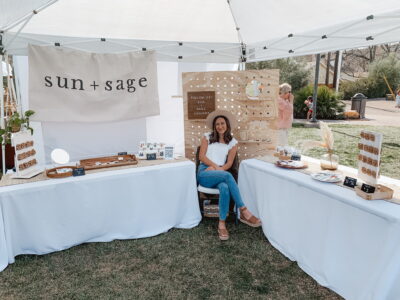 Rachell Torgerson, owner of "Sun + Sage", sits at her booth during a previous market, Date and location unspecified | Photo courtesy of Rachell Torgerson, St. George News