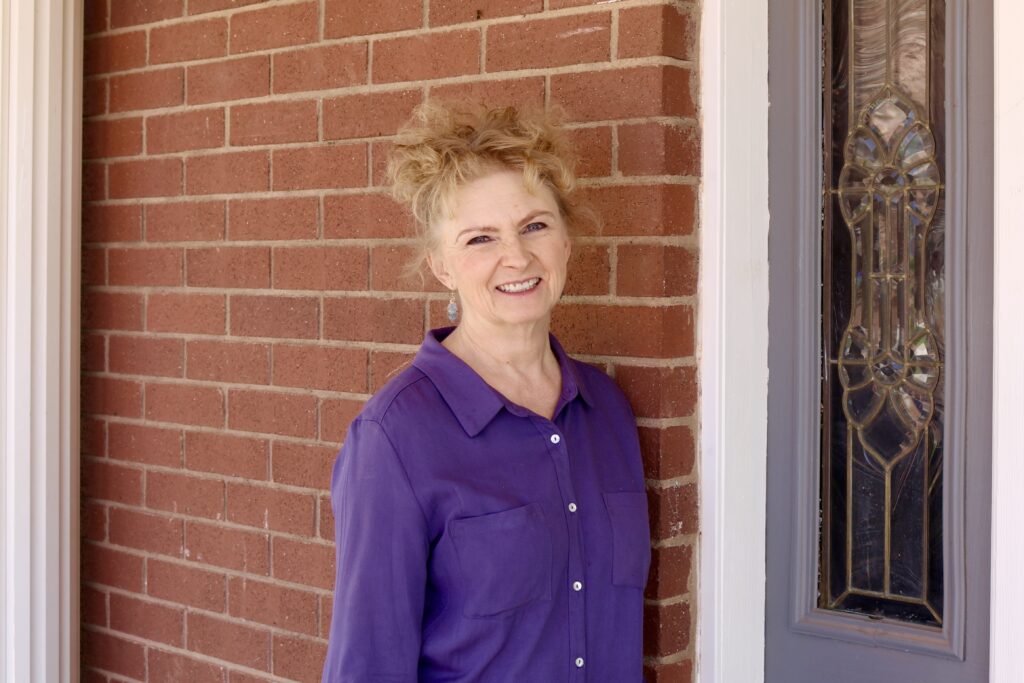 Leanne Worwood stands in front of Rockmore Retreats, a home she and her husband purchased and renovated, Hildale, Utah, May 2, 2022 | Photo by Jessi Bang, St. George News