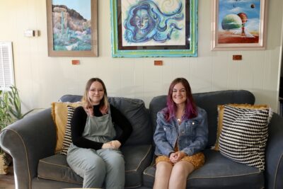 Kyrsten Woodard and Emily Rowley, co-owners of Red Canyon Company sit on a couch inside the book den, Hurricane, Utah, May 5, 2022 | Photo by Jessi Bang, St. George News