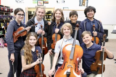 Linda DeLuca stands with her orchestra students at Vista School, Ivins, Utah, May 18, 2022 | Photo by Jessi Bang, St. George News