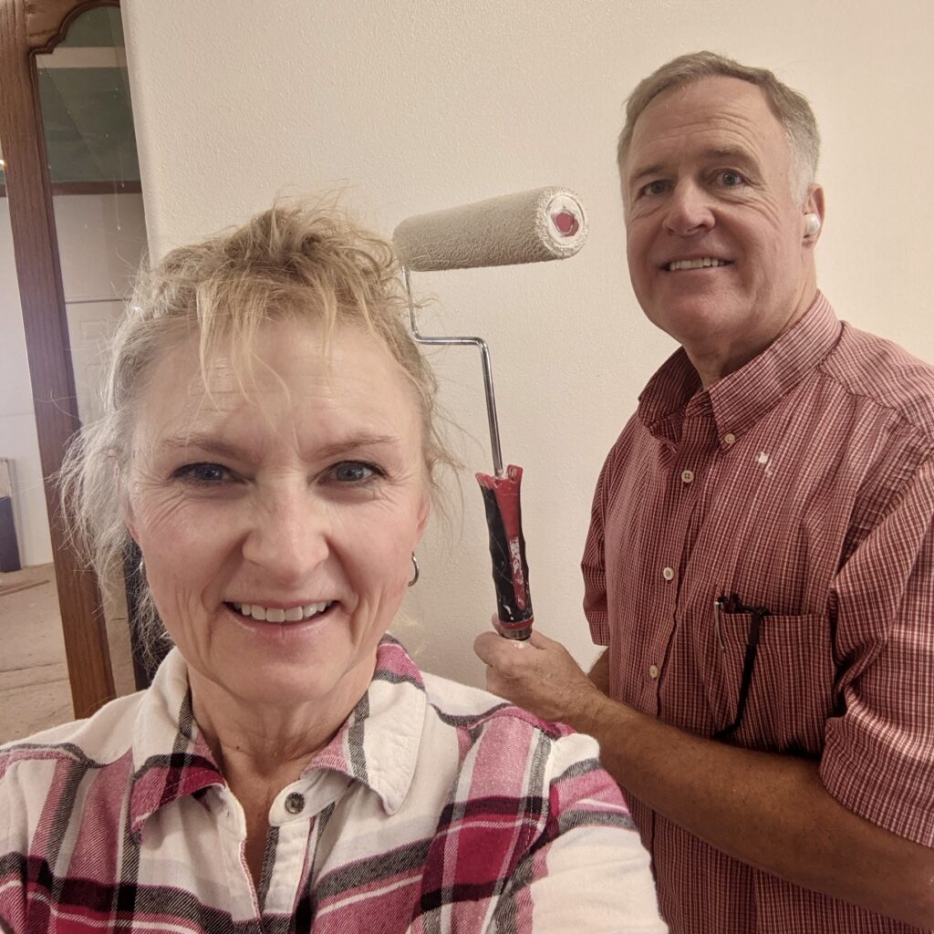 Leanne and Danny Worwood pose with paint rollers during the Rockmoore home renovation project, Hildale, Utah, date unspecified | Photo courtesy of Leanne Worwood, St. George News