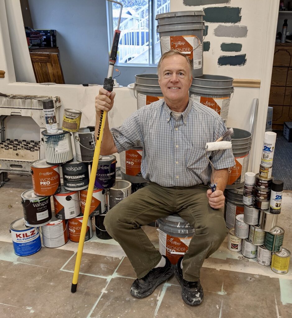 Danny Worwood holds a paint roller next to buckets of paint, Hildale, Utah, date unspecified | Photo courtesy of Leanne Worwood, St. George News