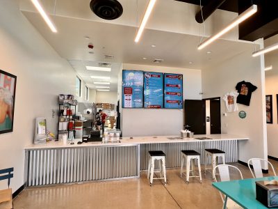 The inside of Quench It! Santa Clara features a purchase desk, along with a menu and stools, Santa Clara, Utah, June 7 2022 | Photo by Jessi Bang, St. George News