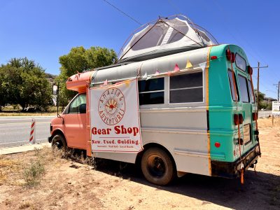 The bus Cindy Alfaro and Jared Wright lived in for two years sits outside the Amazing Adventures Gear Shop, La Verkin, Utah, June 8, 2022 | Photo by Jessi Bang, St. George News