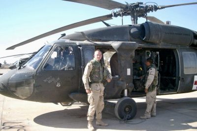 Chris Hobson stands in front of a helicopter while on deployment in Iraq, location and date unspecified | Photo courtesy of Jackie Hobson, St. George News