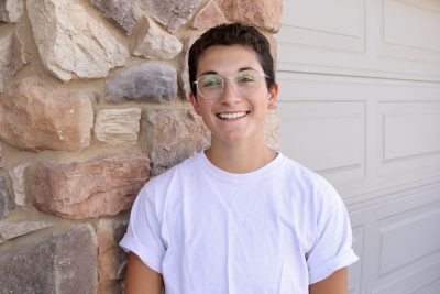 Maggie Cappiello smiles for the camera outside her home, Washington, Utah, August 9, 2022 | Photo by Jessi Bang, St. George News