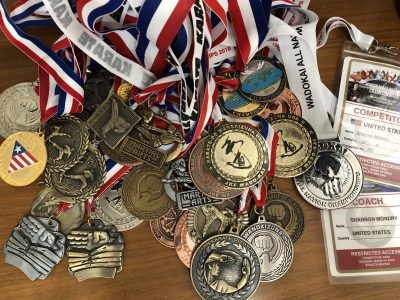 A stack of karate metals Shannon Modry has won lady on a table, location and date unspecified | Photo courtesy of Shannon Modry, St. George News