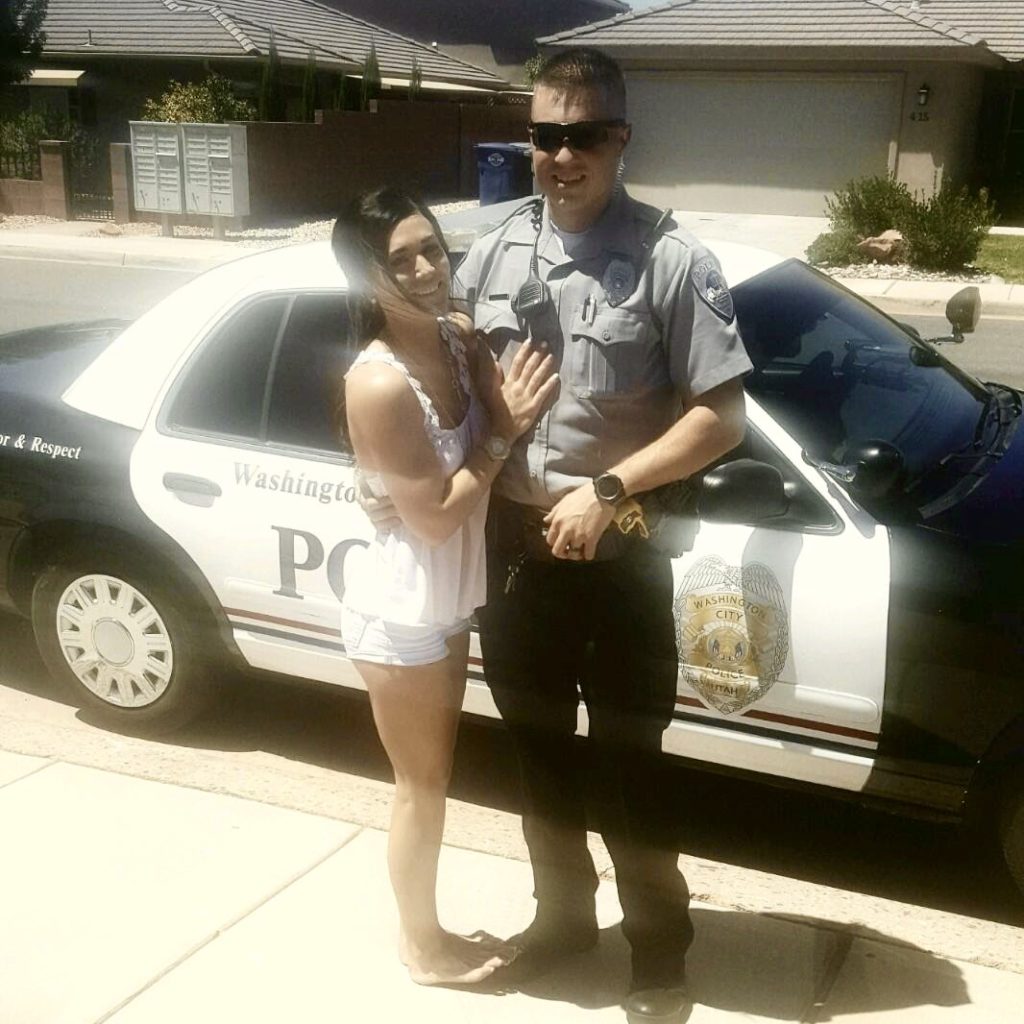 Rustin Staheli poses with his wife in front of his police car, location and date unspecified | Photo courtesy of Rustin Staheli, St. George News
