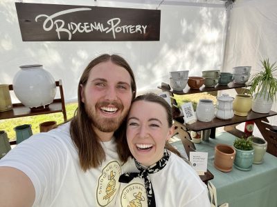 Ridge Merrill and his wife McKinley stand inside their booth at a market, location and date unspecified | Photo courtesy of Ridge Merrill, St. George News