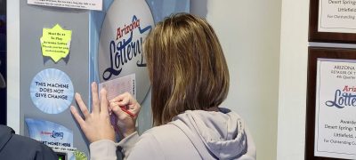 A woman picks her Powerball numbers at a gas station in Littlefield, Arizona, Nov. 6, 2022 | Photo courtesy of Chris Reed, St. George News