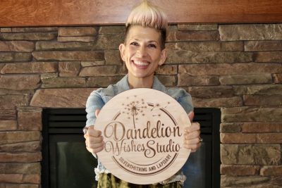 Audra Thompson, owner of Dandelion Wishes Studio, a silversmithing and lapidary company, poses in front of her home fireplace in St. George, Utah, Oct. 31, 2022 | Photo by Jessi Bang, St. George News