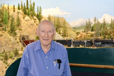 Jim Harper stands inside his train room next to his handcrafted display, Santa Clara, Utah, Nov. 1, 2022 | Photo by Jessi Bang, St. George News