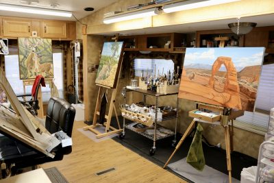 Paintings by Linda Toombs sits inside her trailer studio in Hurricane, Utah, Jan. 11, 2023 | Photo by Jessi Bang, St. George News