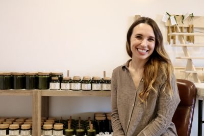 Valerie Keltner, owner of Moonstruck Naturals, takes a photo next to her homemade, non toxic candles, St. George, Utah, Jan. 30, 2023 | Photo by Jessi Bang, St. George News