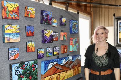 Artist Julianne Skinner stands next to her artwork at her home studio in St. George, Utah on Feb. 27, 2023 | Photo by Jessi Bang, St. George News