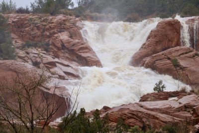 Waterfalls flow down the red rocks at Gunlock State Park in Gunlock, Utah, March 15, 2023 | Photo by Jessi Bang, St. George News