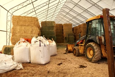 Piles of hay and bags of corn are seen at Buck Brand Beef in Kanab, Utah on March 16, 2023 | Photo by Jessi Bang, St. George News