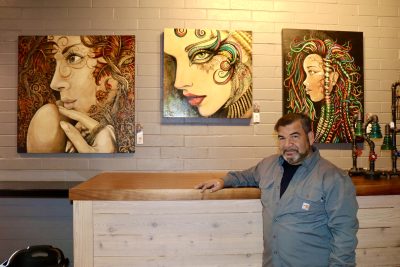 Fernando Sotomayor poses next to his artwork at Morty's Cafe in St. George, Utah on March 21, 2023 | Photo by Jessi Bang, St. George News