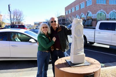 Patrick Sullivan takes a picture with his wife Susan Sullivan next to his sculpture "O'Keefe 10", St. George, Utah, Jan. 11, 2024 | Photo by Jessi Bang, St. George News