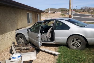 A car that entered a roundabout at high speeds ends up face-first into the side of a home, St. George, Utah, Feb.25, 2024 | Photo courtesy of Winterton Towing, St. George News