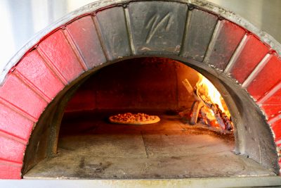 Pizza is cooked in a wood-fired oven aboard the Blazin Hearth Mobile Wood Fired Kitchen, St. George, Utah, April 9, 2024 | photo by Jessi Bang, St. George News
