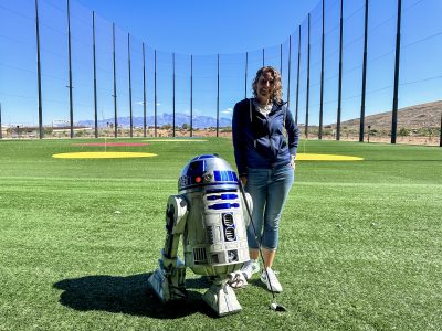 Event Producer Melynda Fanene with GTHR1 Productions takes a photo with R2-D2 at BigShots Golf in St. George, Utah, April 29, 2024 | Photo by Jessi Bang, St. George News